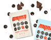 Myna Snacks bags resting on a table, surrounded by Midnight Mini cookies and chunks of chocolate
